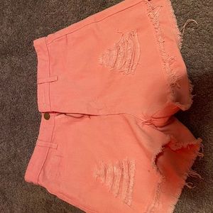 Pink jean shorts with rips
